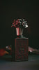 Meihana Eau de Parfum, the bottle turning in low light